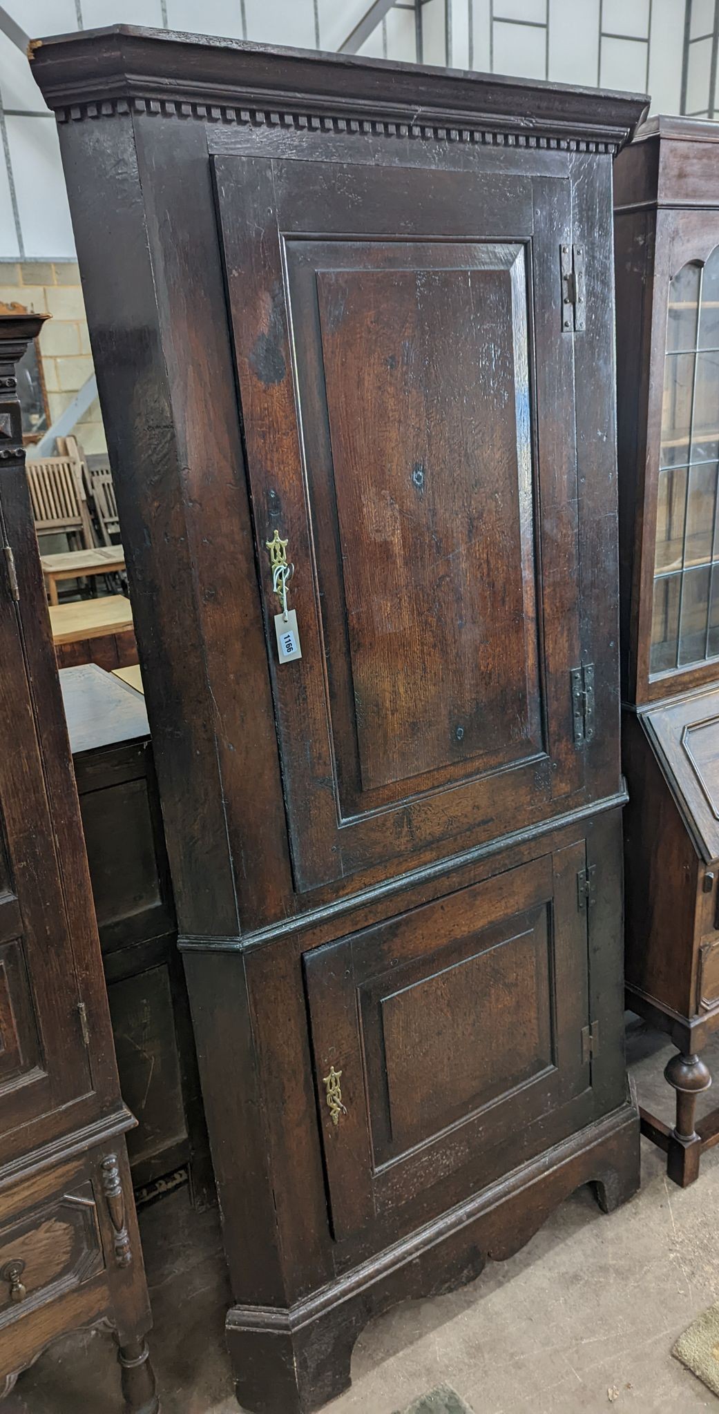 A George III oak standing corner cabinet, width 94cm, depth 38cm, height 202cm